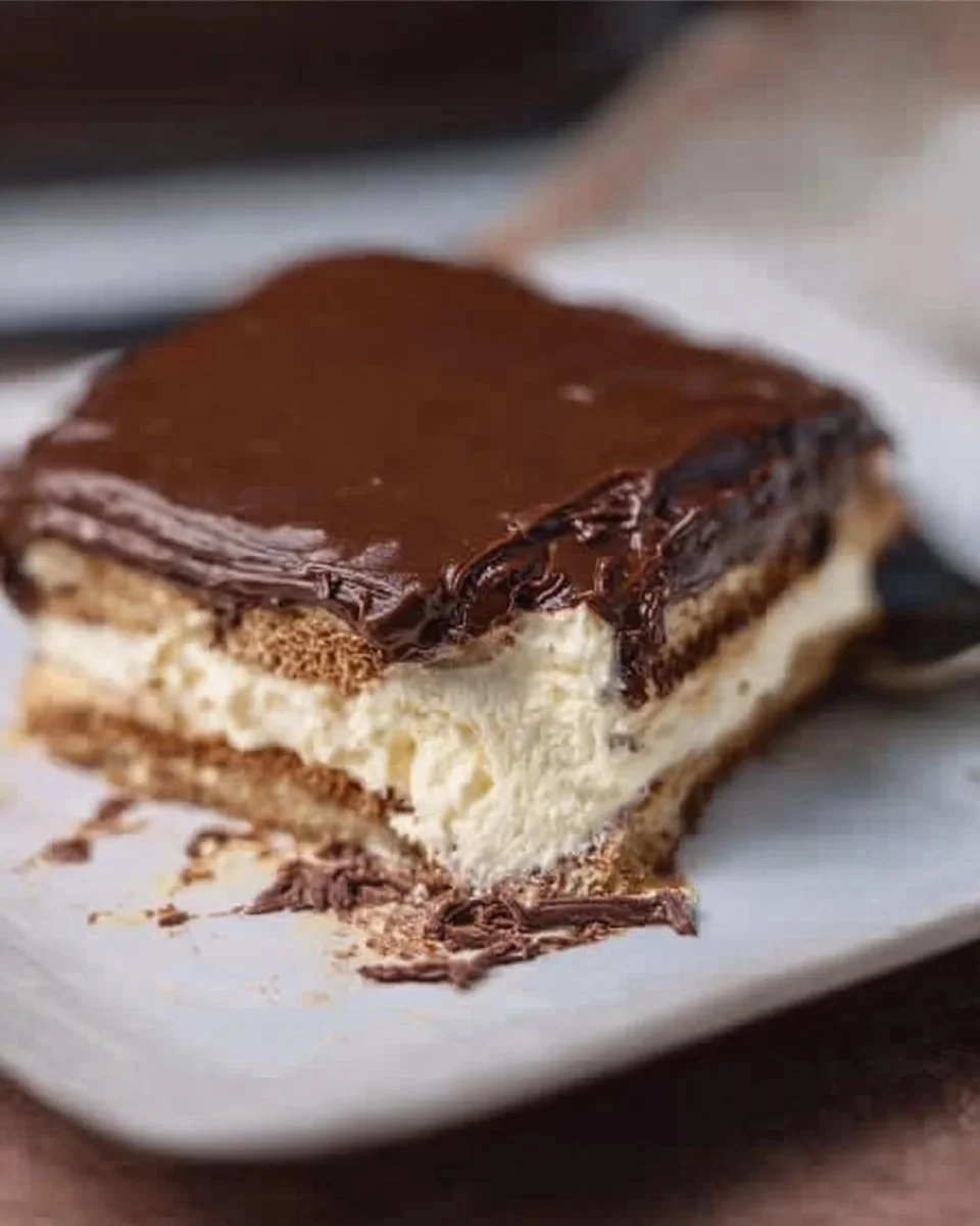 Chocolate Eclair Cake — Easy Make-Ahead Dessert 1 Delicious Chocolate Eclair Cake, an easy make-ahead dessert for any occasion.