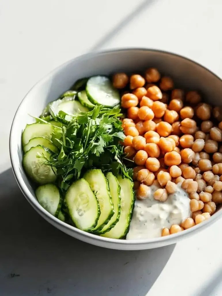 Healthy grain bowls with chickpeas and tahini dressing in a vibrant bowl
