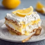 Slice of no-bake lemon icebox cake served on a plate with lemon slices