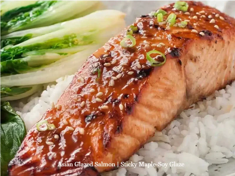 Delicious Asian glazed salmon with sticky maple-soy glaze garnished with sesame seeds.