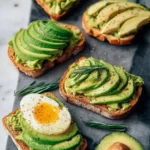 Delicious avocado toast topped with creamy smashed avocado and garnishes