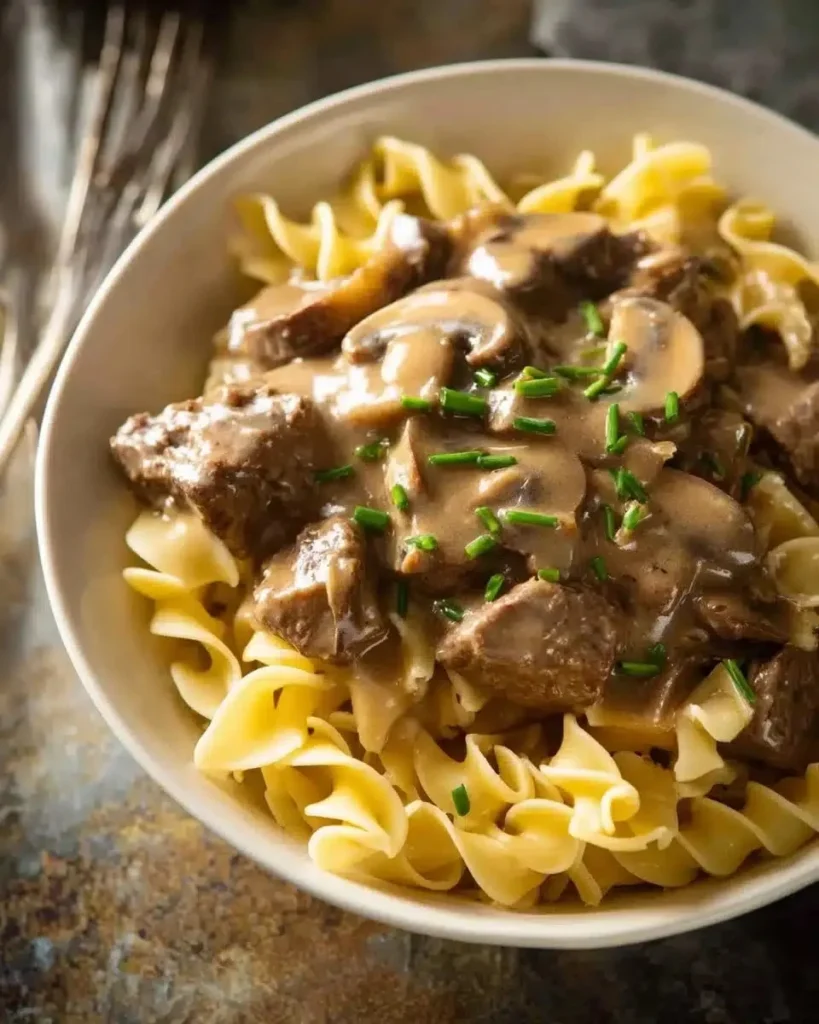 Delicious Beef Stroganoff served with creamy sauce and pasta.