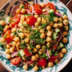 Colorful chickpea salad with fresh vegetables in a bowl