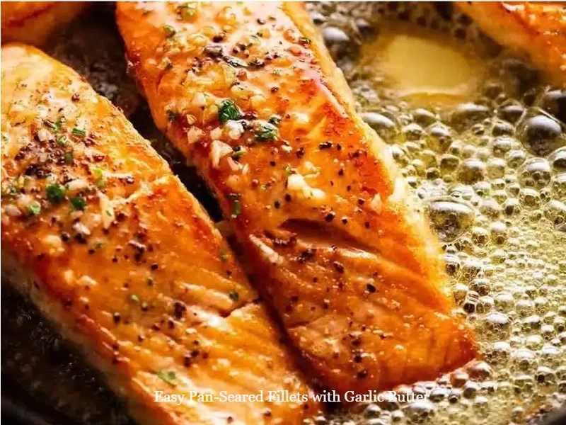 Delicious pan-seared fillets seasoned with garlic butter on a plate.