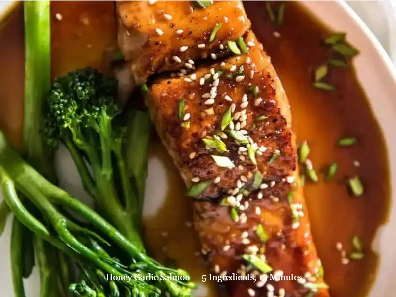 Cooked honey garlic salmon fillet on a plate garnished with herbs