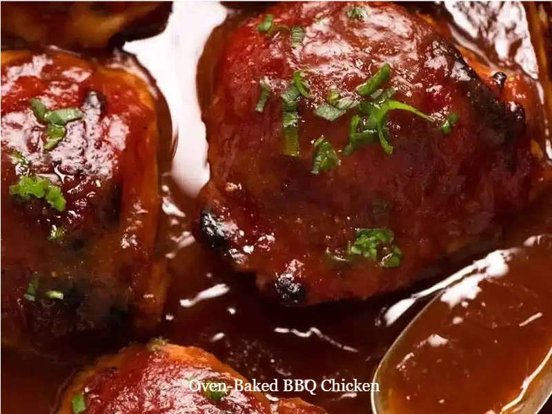 Oven-baked BBQ chicken ready to serve on a plate with fresh herbs.
