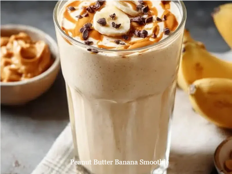 Delicious peanut butter banana smoothie in a glass with a straw.
