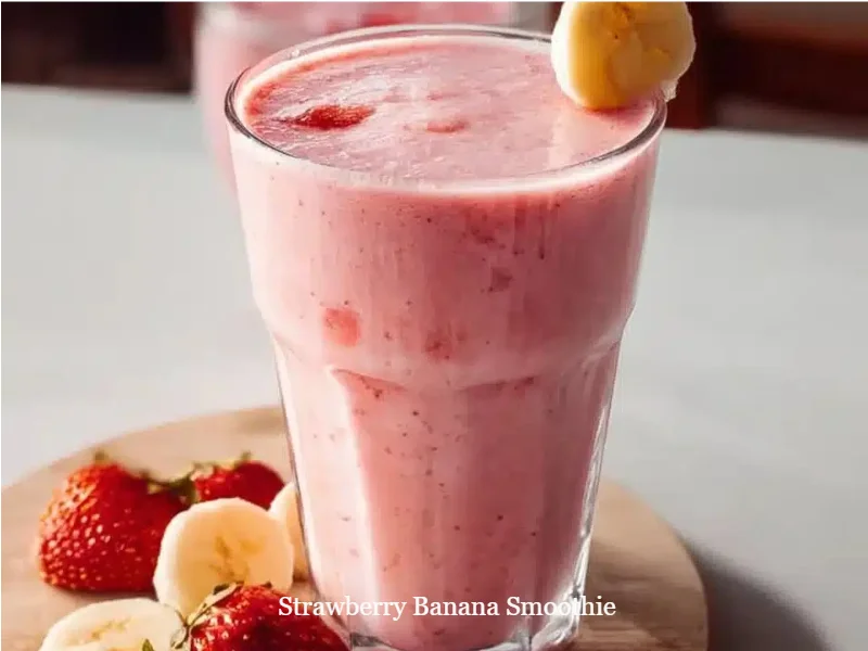 Strawberry banana smoothie in a glass with fresh fruit
