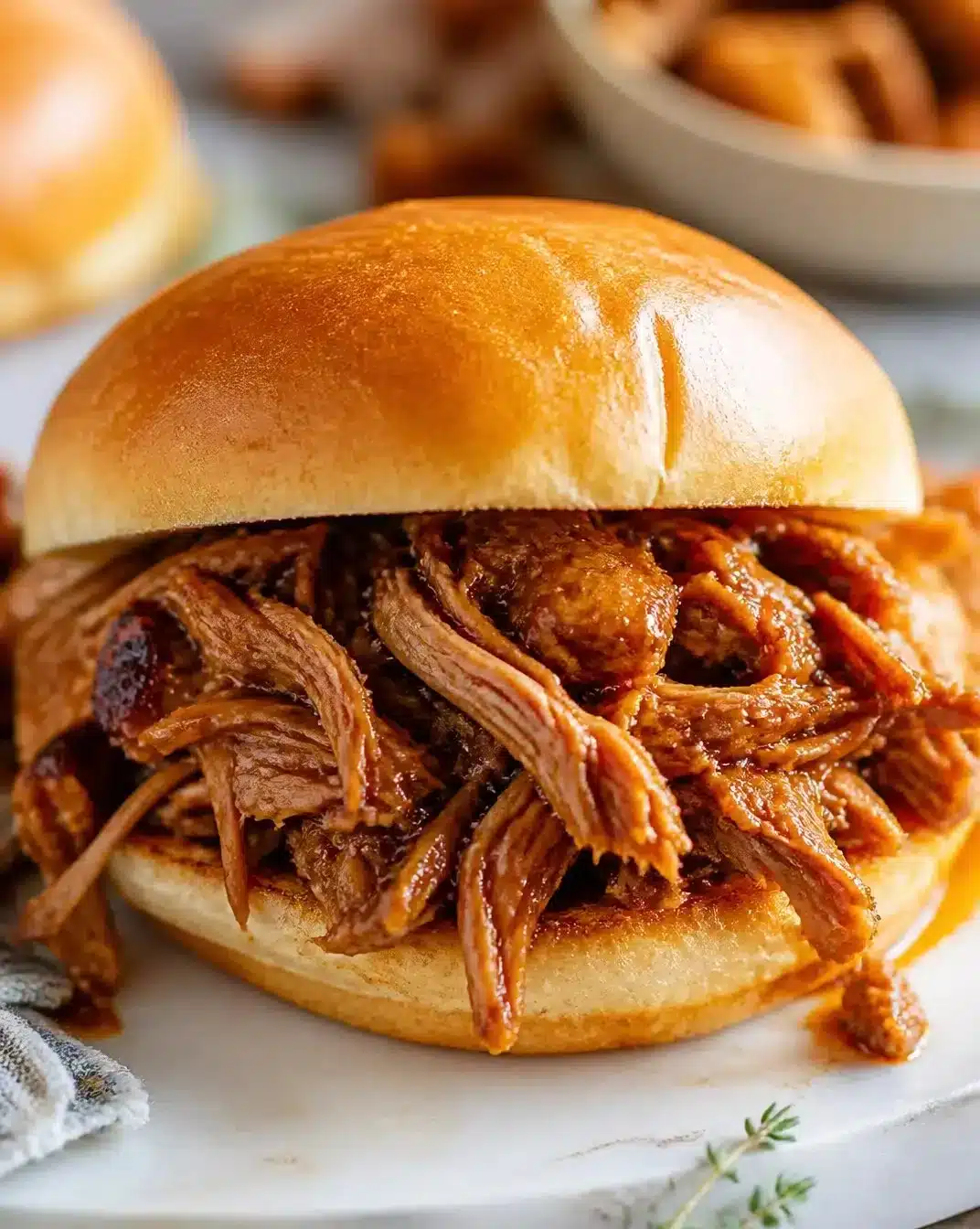 Delicious slow-cooker pulled pork served with barbecue sauce and coleslaw
