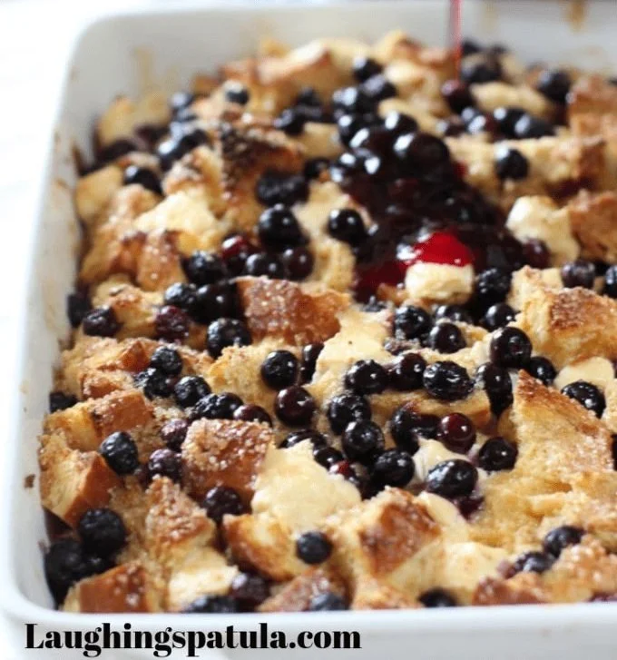 Blueberry Swirl French Toast Bake topped with fresh blueberries and maple syrup