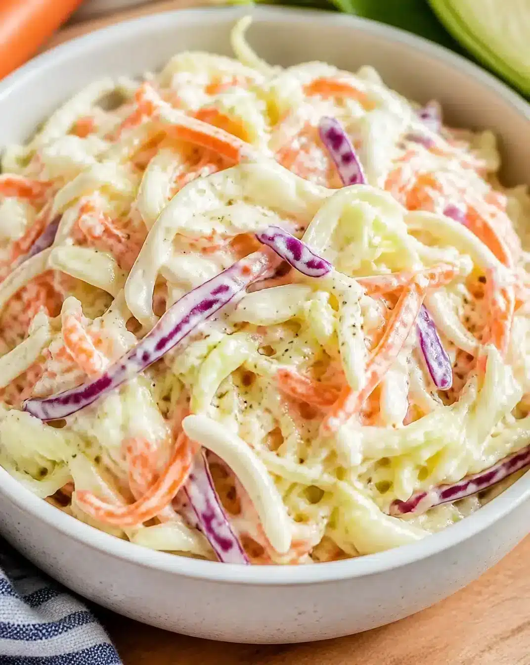 Bowl of creamy coleslaw with fresh cabbage and dressing