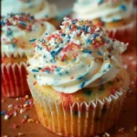 Fireworks-inspired funfetti cupcakes topped with colorful sprinkles and frosting