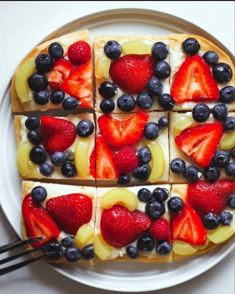 Delicious homemade simple fruit pizza topped with fresh fruits and cream cheese
