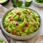 Bowl of traditional guacamole made with fresh avocados and seasonings